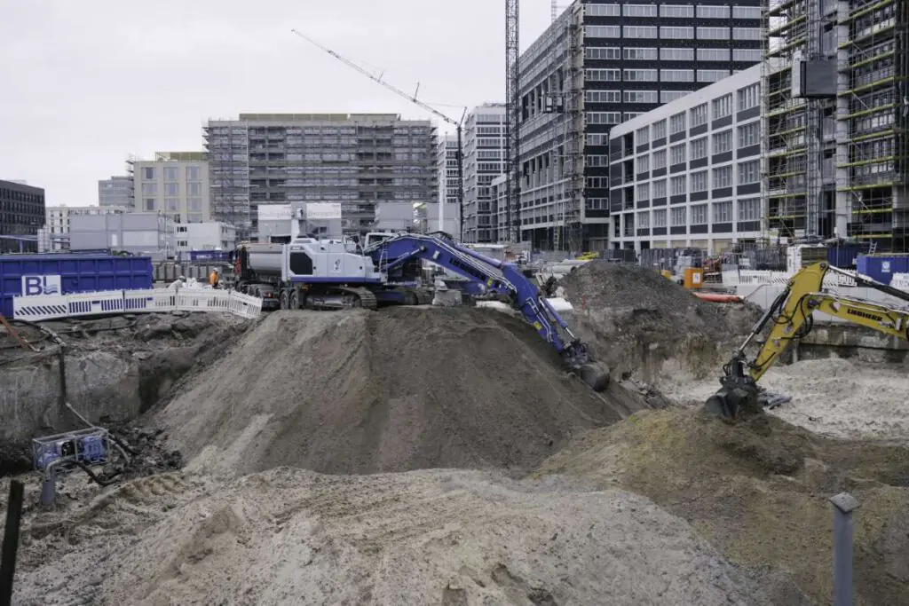 Baustelle in Berlin-Mitte: Aus Abfall wird Ressource. Natürlich-gewachsener Boden weicht einem Neubauvorhaben. Im Hintergrund stehen LKW für den Abtransport des Aushubs bereit. ©Alexander Jerosch- Herold, Jakob Krauss, 2023